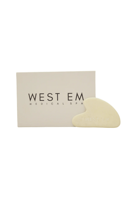 West Em Gua Sha lymphatic drainage tool for facial massage to promote circulation and reduce puffiness at West Em Medical Spa